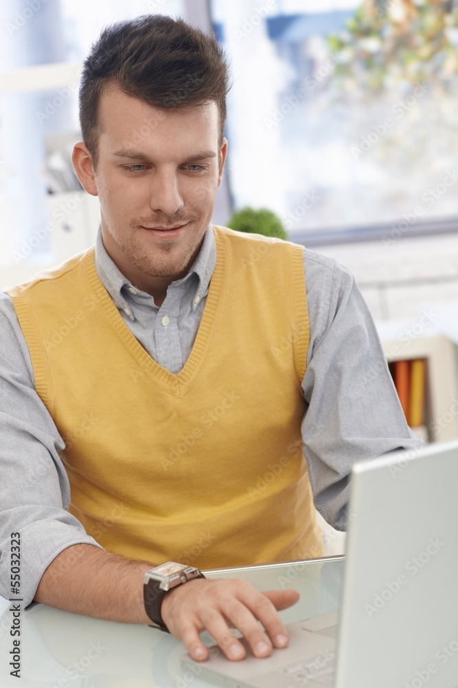 Young man using laptop computer Young man using laptop computer