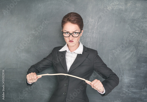 Quadro su tela Angry teacher with wooden stick