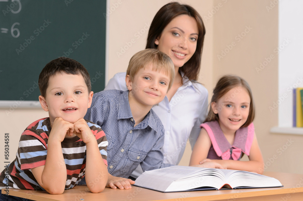 Teacher and pupils. Confident young teacher sitting together wit