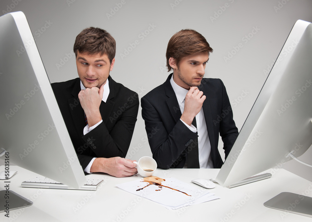 Dirty business. Young man in formalwear pouring coffee on the do Dirty business. Young man in formalwear pouring coffee on the do
