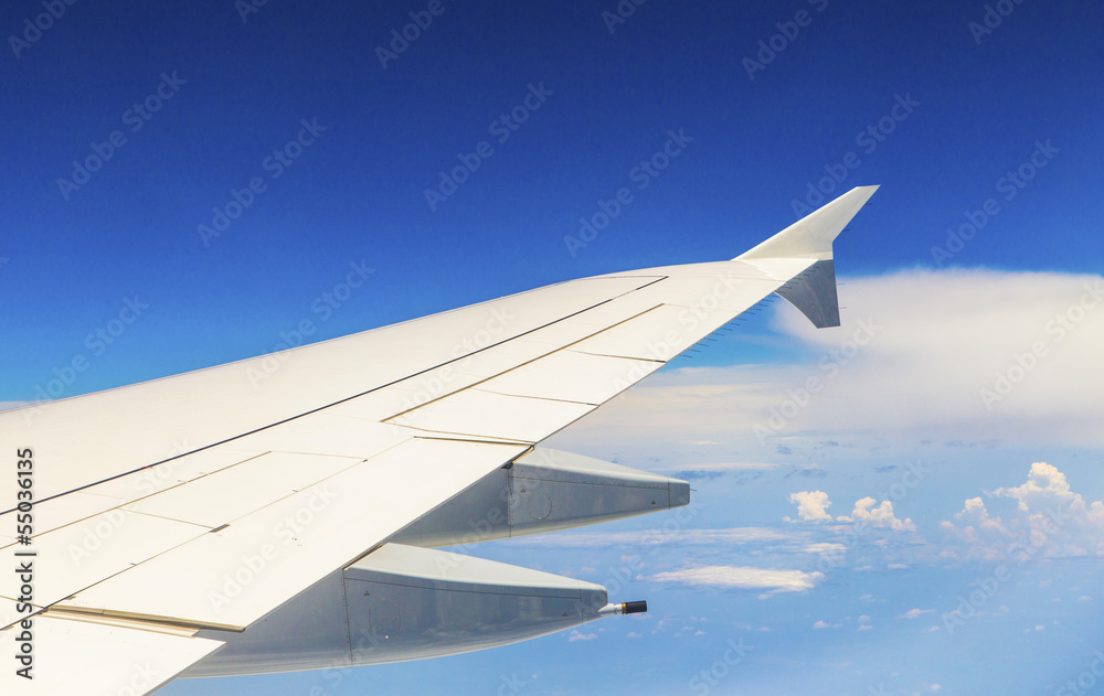 wing of aircraft in the blue sky wing of aircraft in the blue sky