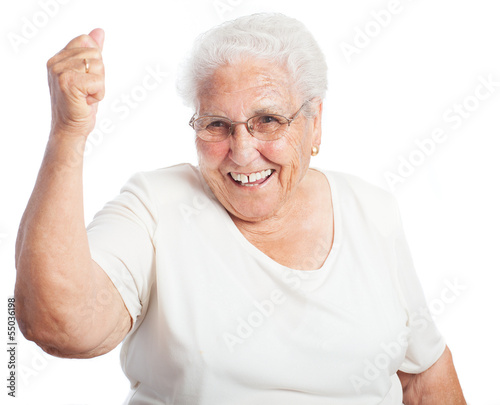 Elder woman celebrating something on a white background
