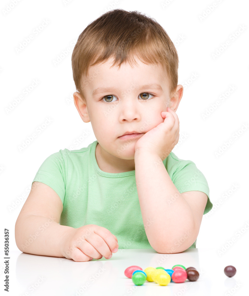 Portrait of a sad little boy with candies Portrait of a sad little boy with candies