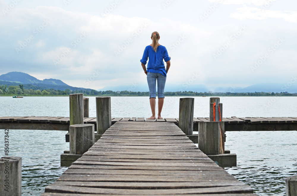 Girl on the wooden jetty. Switzerland