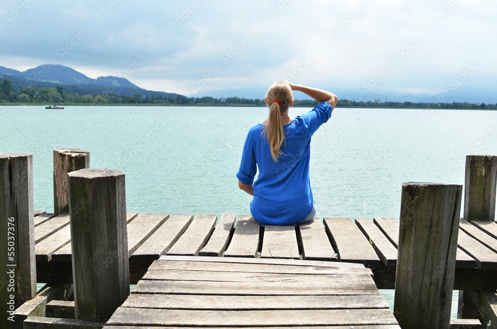 Girl on the wooden jetty. Switzerland