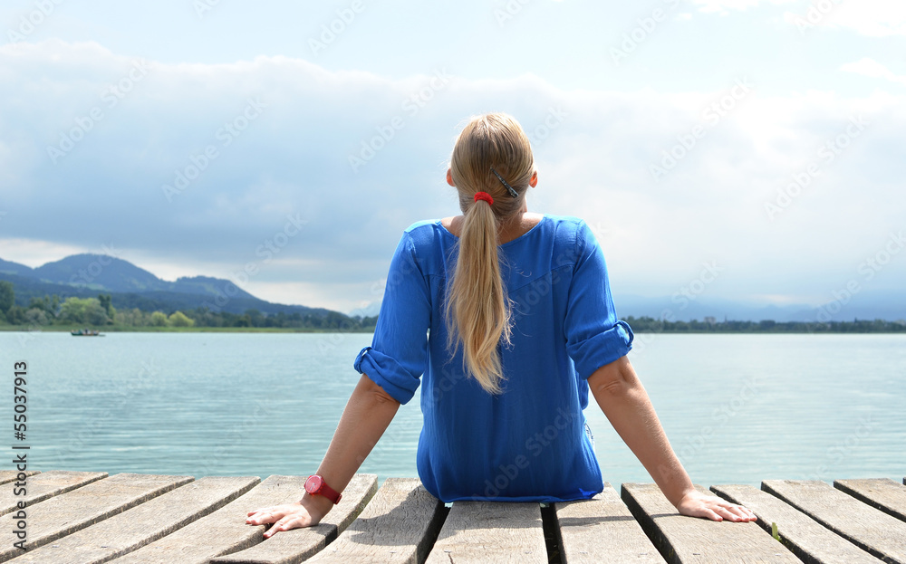Fototapeta premium Girl on the wooden jetty. Switzerland