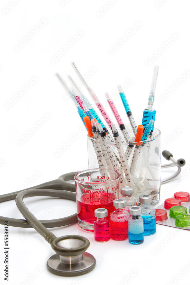 Medical bottles, ampoule, syringe and pills with stethoscope Medical bottles, ampoule, syringe and pills with stethoscope
