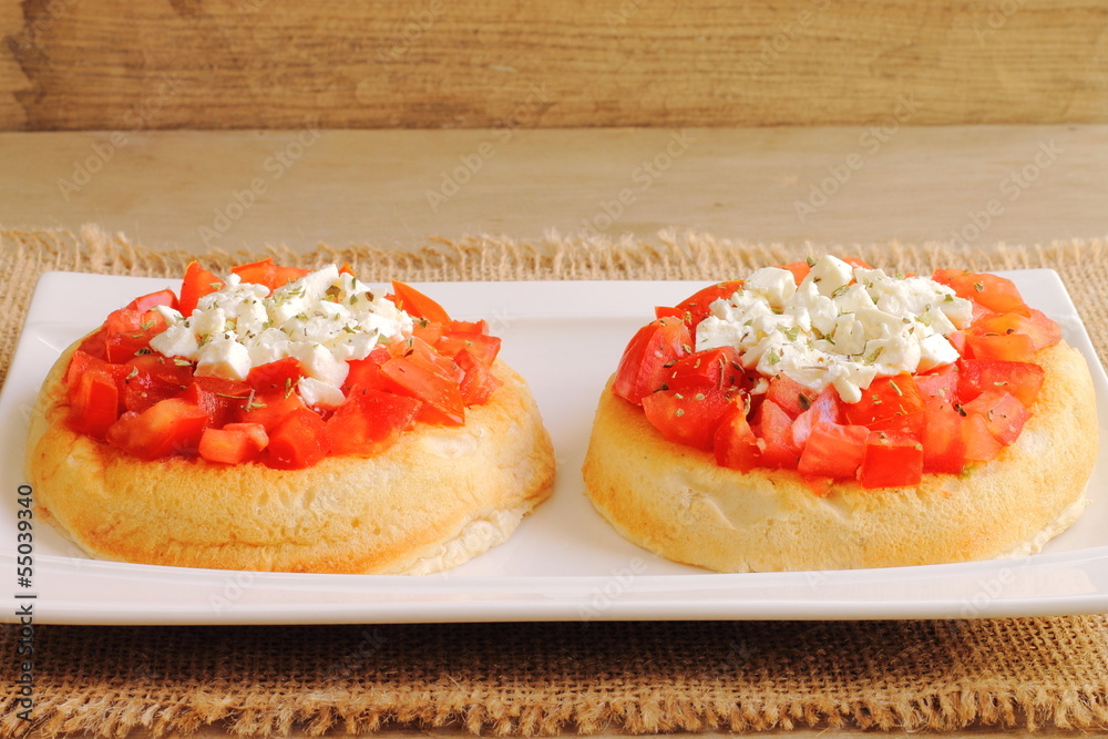 Dakos, Cretan recipe with bread, tomato, feta and oregano Dakos, Cretan recipe with bread, tomato, feta and oregano