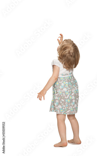 Little baby girl showing something above her