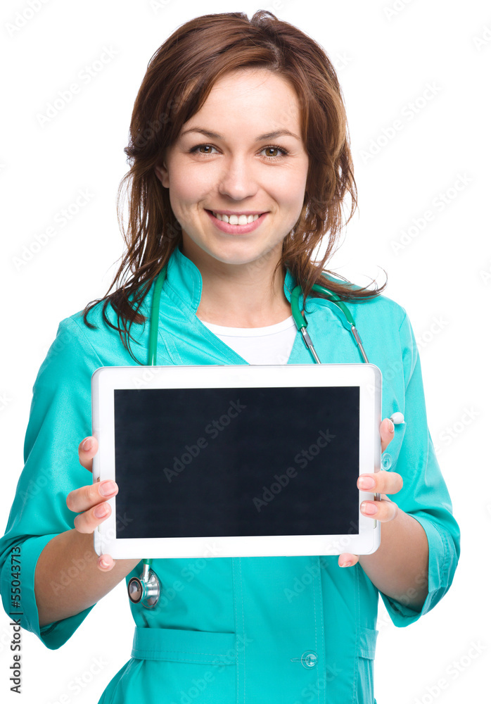 Young cheerful doctor is showing her blank tablet Young cheerful doctor is showing her blank tablet