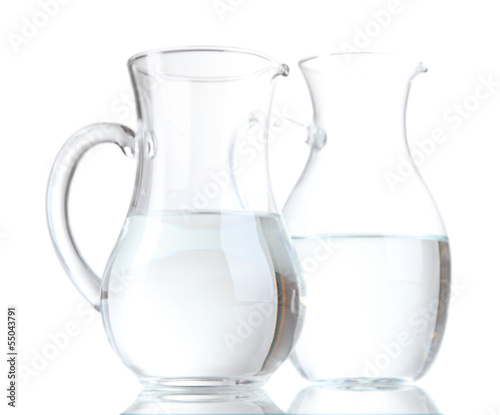 Glass pitchers of water isolated on white