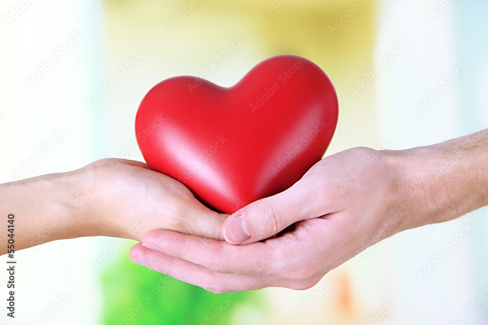 Heart in hands on light background Heart in hands on light background
