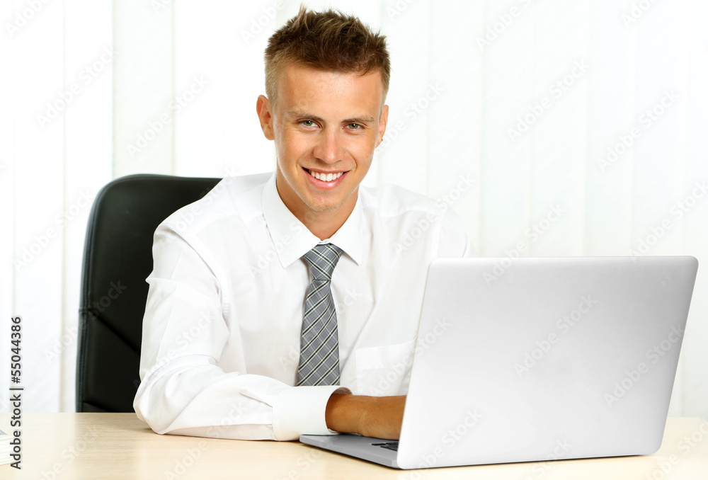 Portrait of young businessman working in office Portrait of young businessman working in office