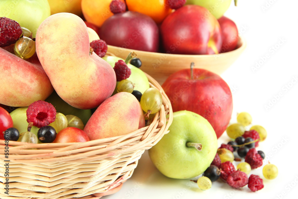 Assortment of juicy fruits in wicker basket and wooden bowl, Assortment of juicy fruits in wicker basket and wooden bowl,