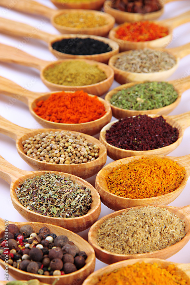 Assortment of spices in wooden spoons Assortment of spices in wooden spoons