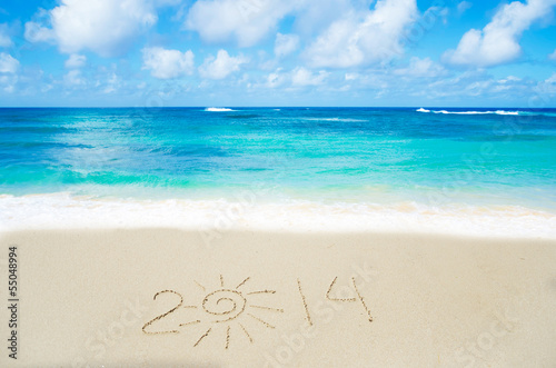 Number 2014 on the sand - holiday concept