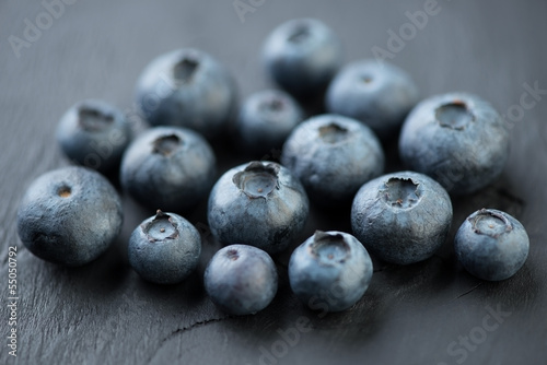 Ripe blueberries on black wooden background