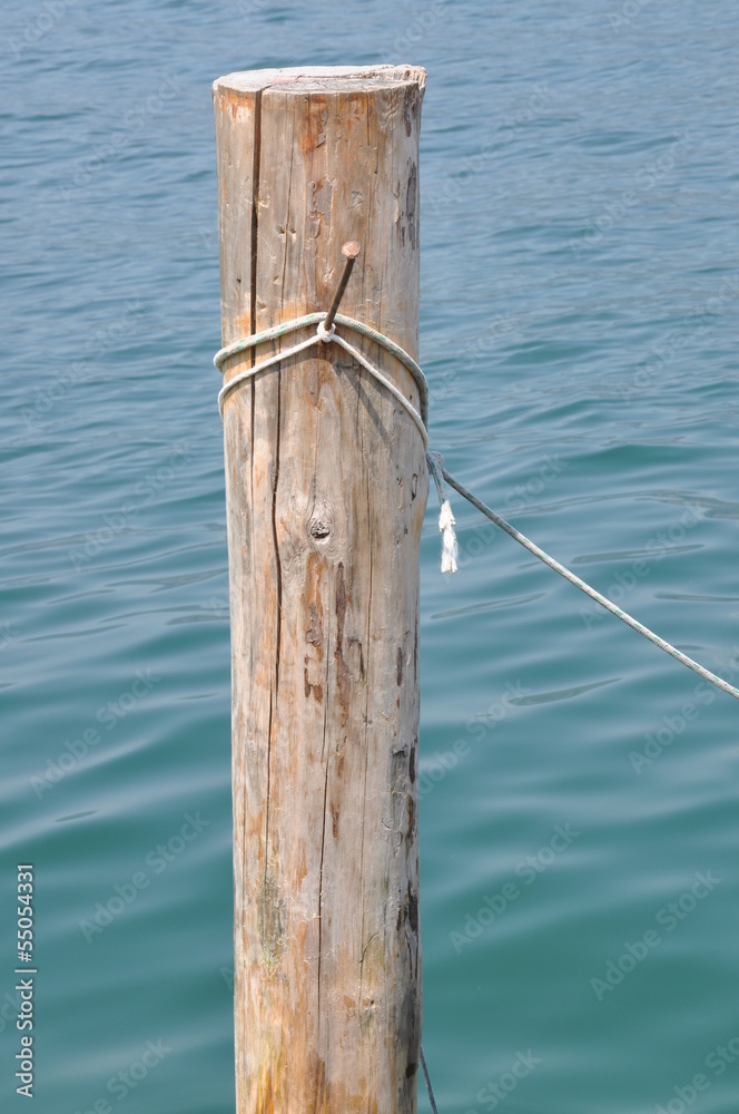 Single wooden bollard with rope Single wooden bollard with rope