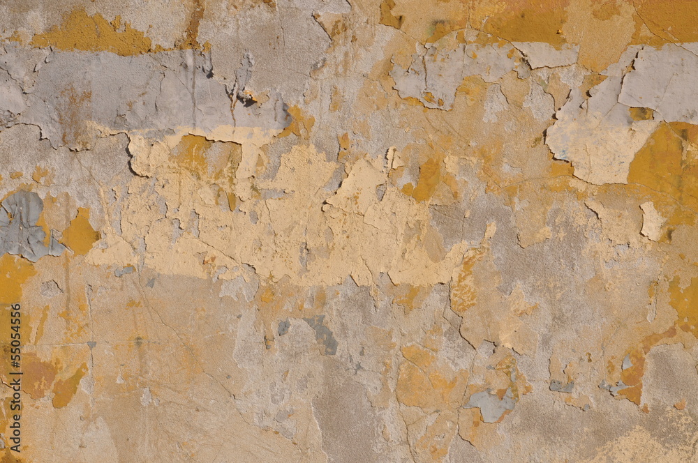 Old wall with peeling yellow paint