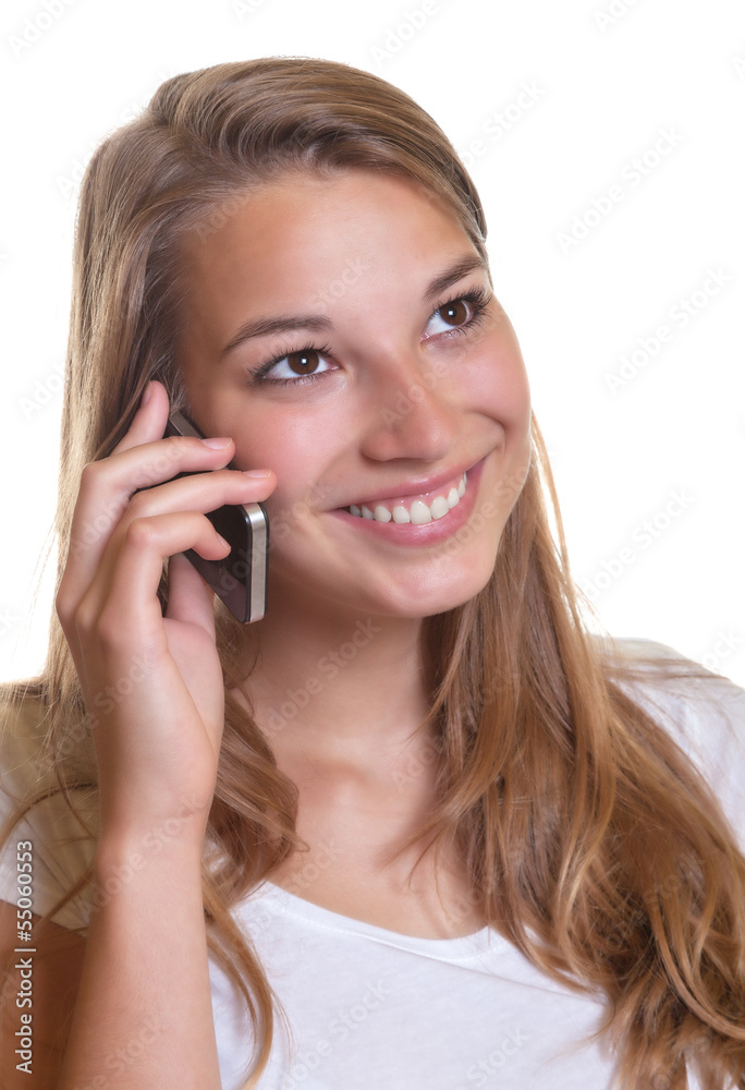 Smiling young girl is happy about the news on the phone Smiling young girl is happy about the news on the phone