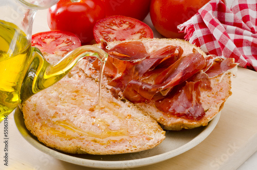 Spanish Cuisine. Tomato bread and Serrano Ham. Pa amb tomaquet i