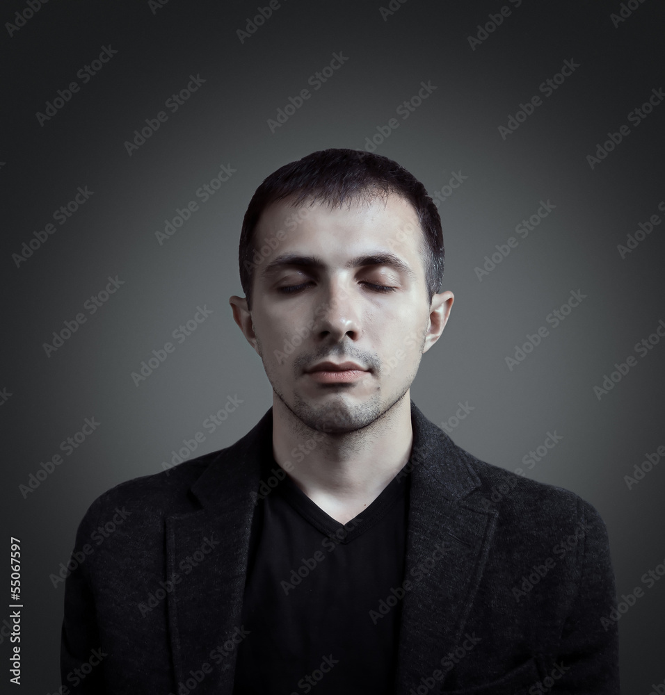 Man in jacket is meditating Man in jacket is meditating