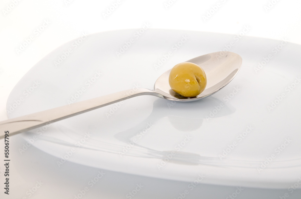 Spoon with olive on white background Spoon with olive on white background
