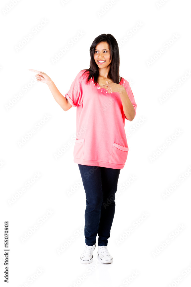 Happy , excited young woman pointing on copy space Happy , excited young woman pointing on copy space