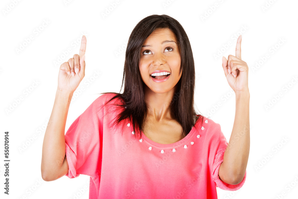 Happy , excited young woman pointing on copy space Happy , excited young woman pointing on copy space