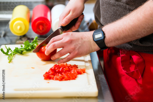 chef making hotdog in fast food snack bar