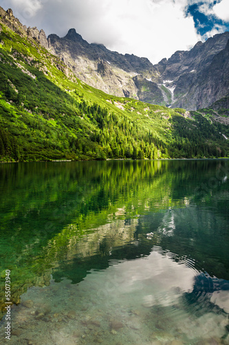 Fototapeta Naklejka Na Ścianę i Meble -  Small mountain lake with blue water and rocky mountains