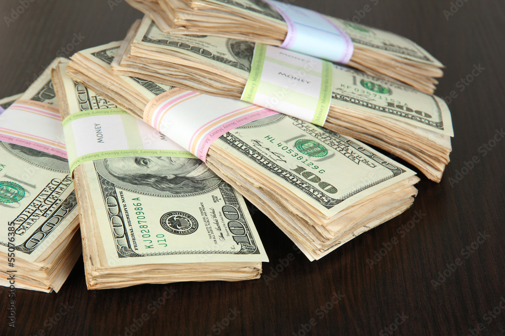 Stacks of money on wooden table Stacks of money on wooden table