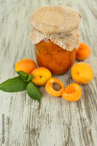 Apricot jam in glass jar and fresh apricots,