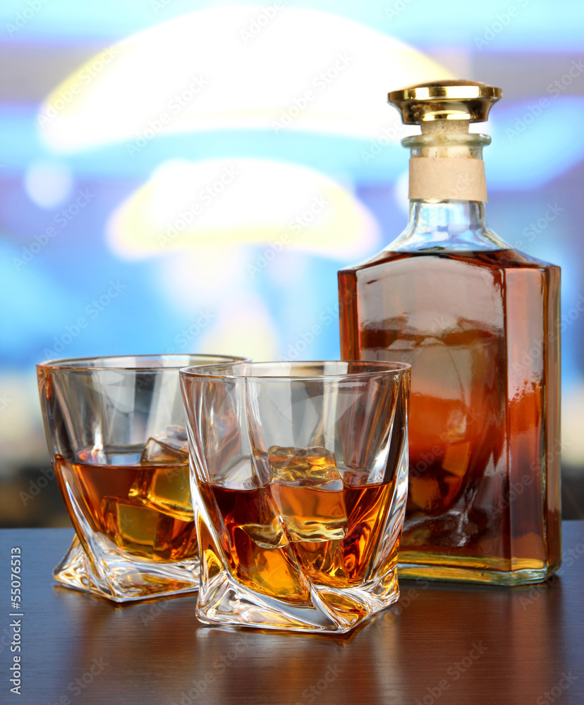 Glass of whiskey with bottle, on dark background Glass of whiskey with bottle, on dark background