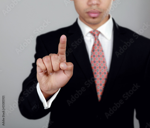 Business man touching an imaginary screen or button