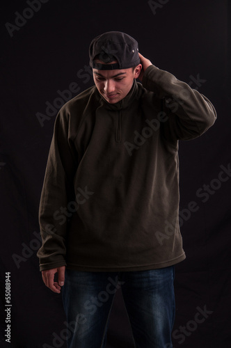 Goofy teenager wearing trendy cap, with a funny expression on hi