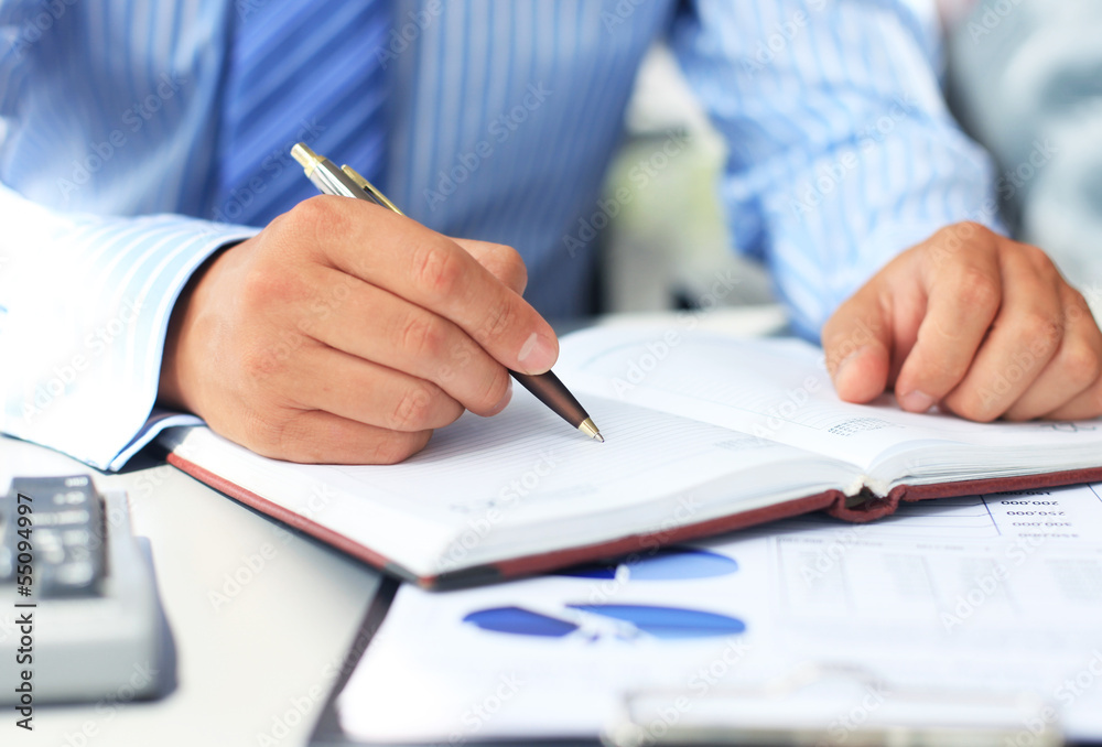 Close-up of graphs and charts analyzed by businessman Close-up of graphs and charts analyzed by businessman