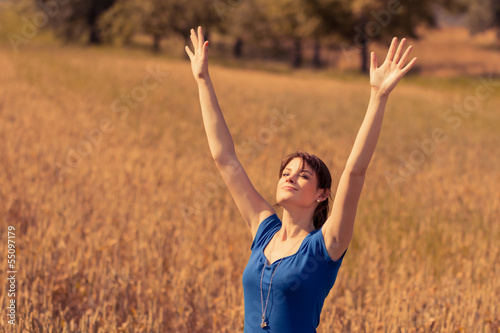 Beautiful young woman with enjoying the sun in nature