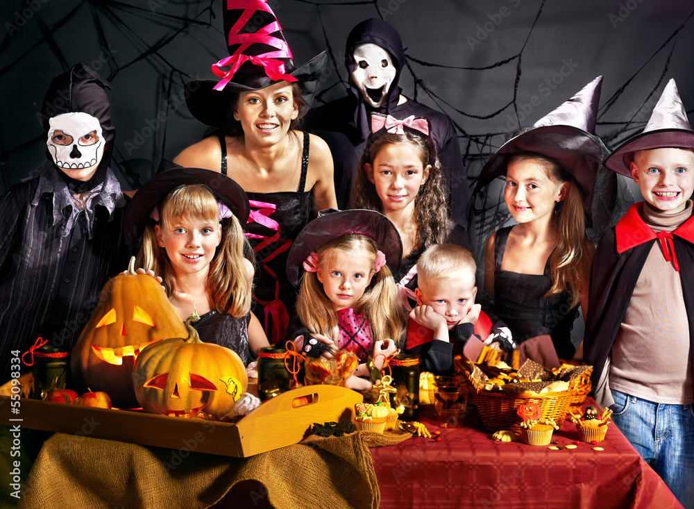 Children on Halloween party making pumpkin Children on Halloween party making pumpkin