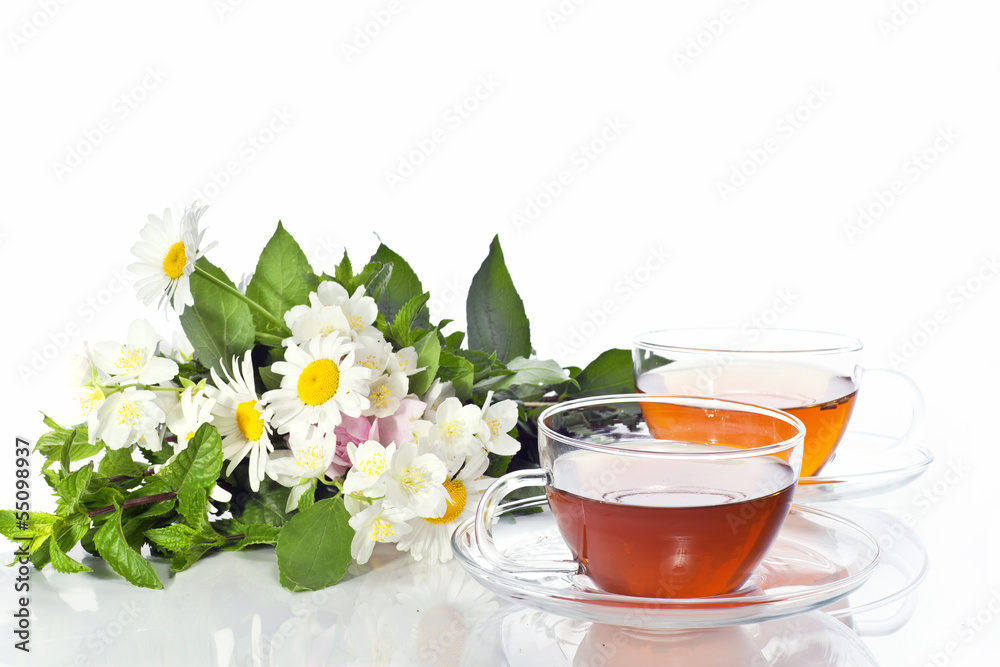 Transparent cup with green tea and fresh herbal bouquet Transparent cup with green tea and fresh herbal bouquet