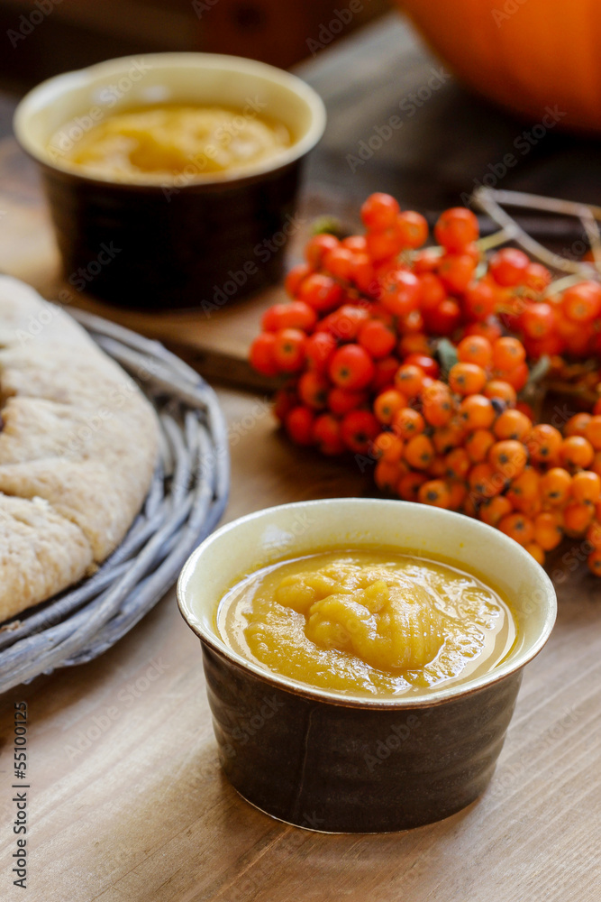 Pudding in black bowl, autumn setting. Selective focus Pudding in black bowl, autumn setting. Selective focus