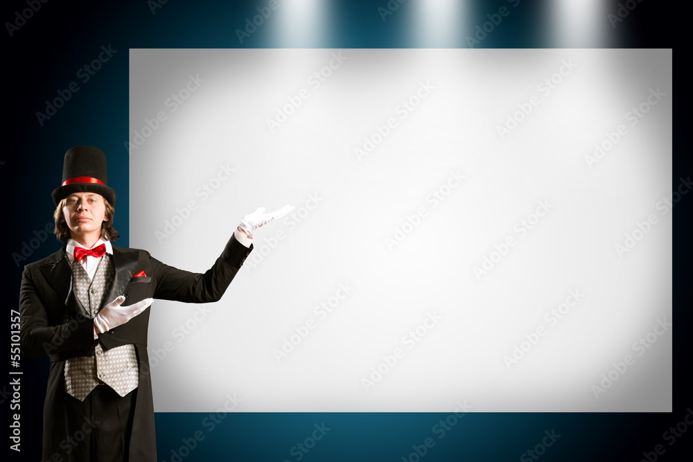 magician in top hat and tie points to the banner magician in top hat and tie points to the banner