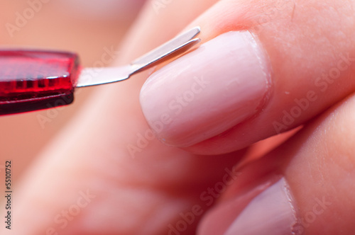girl cuts the skin at the nail