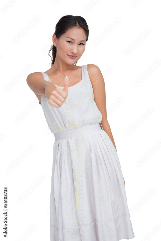 Positive model looking at camera giving thumb up Positive model looking at camera giving thumb up