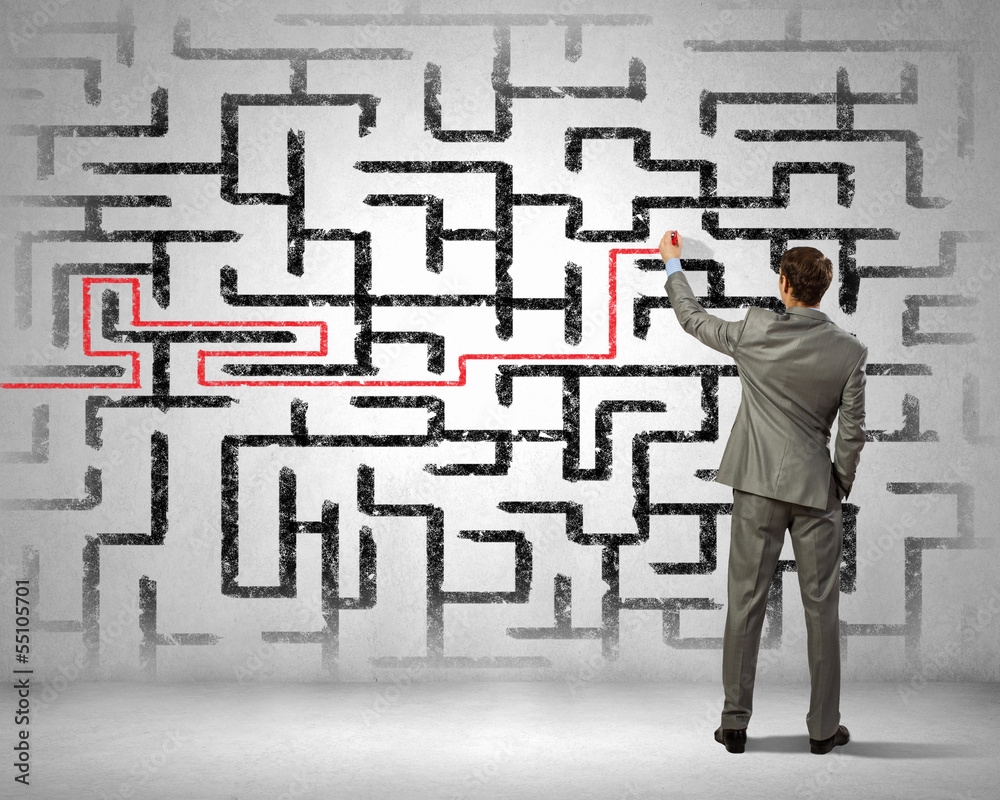 Businessman solving labyrinth problem Businessman solving labyrinth problem