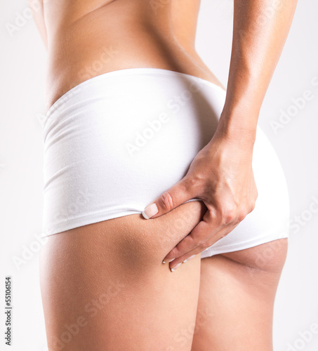 Woman with perfect body checking cellulite