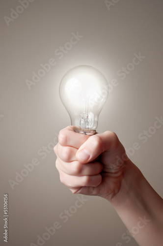 Hand with light bulb