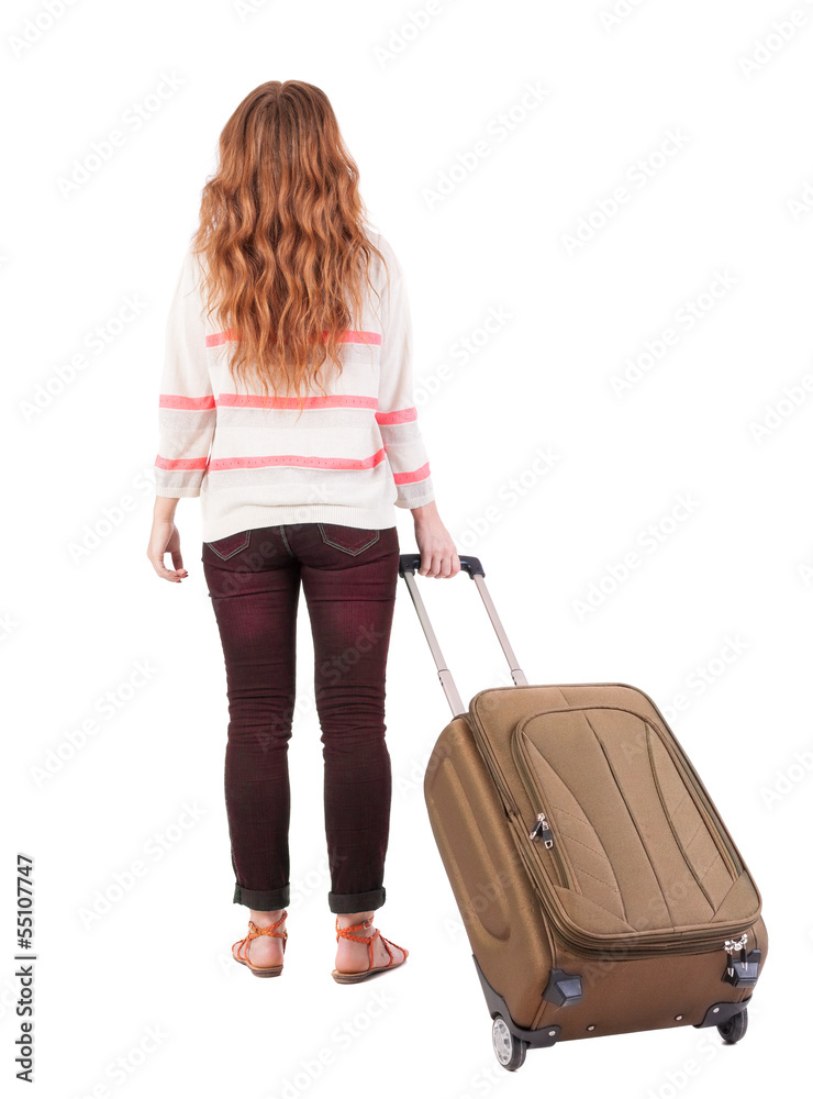 back view of walking woman with suitcase. back view of walking woman with suitcase.