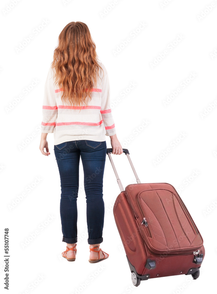 back view of walking woman with suitcase. back view of walking woman with suitcase.