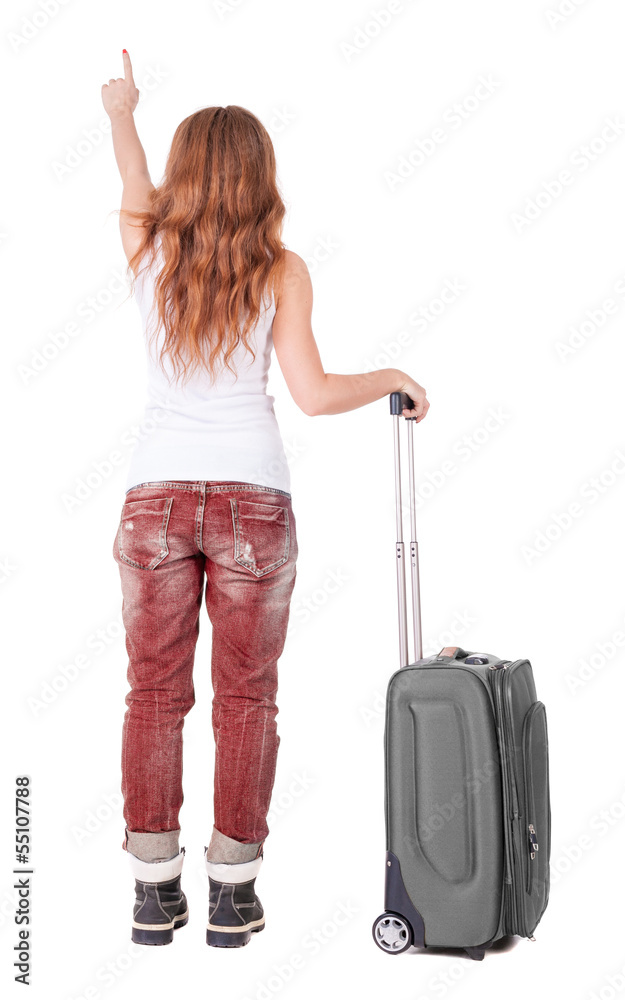 Back view of pointing woman with suitcase looking up Back view of pointing woman with suitcase looking up